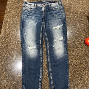 Silver distressed ankle jeans.